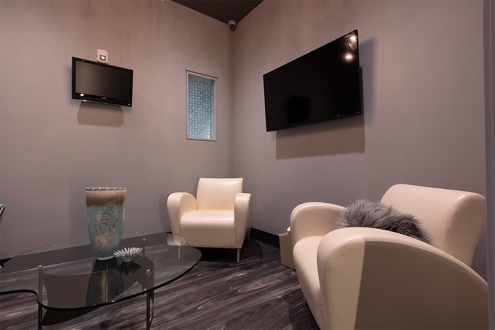 The patient lounge with upholstered armchairs