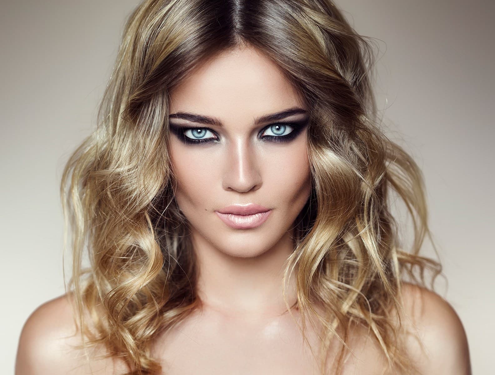 A woman with clear, even-toned skin and auburn hair